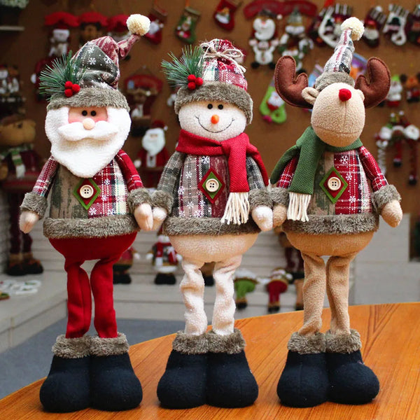 Three Christmas-themed figurines on a wooden surface with a festive background.