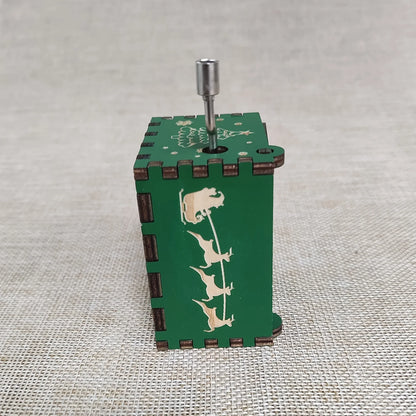 Green wooden music box with animal designs on a textured surface