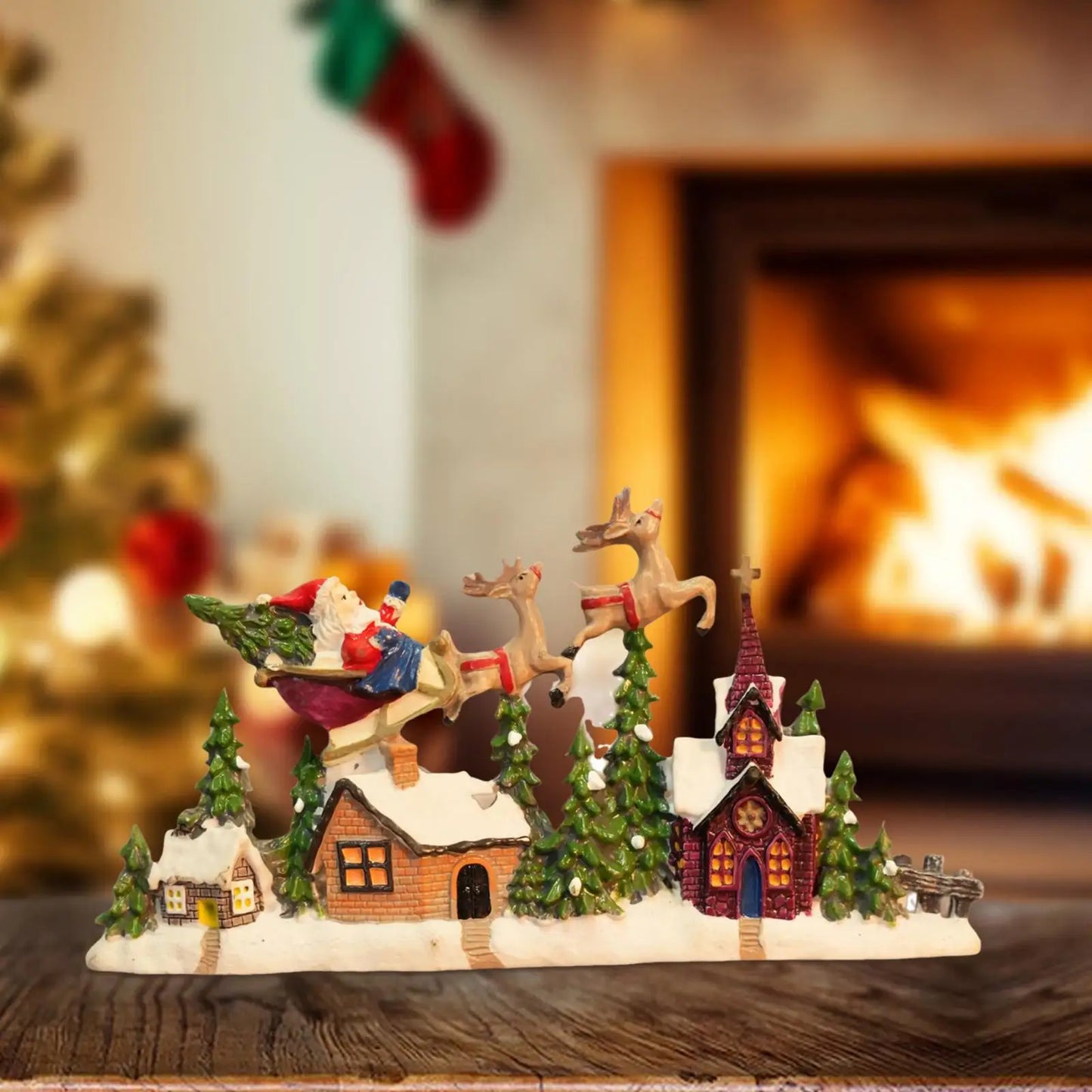 Decorative Christmas scene with Santa Claus, reindeer, and houses in front of a fireplace.