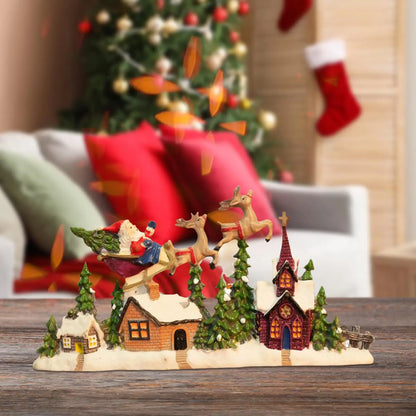 Christmas-themed village scene with Santa Claus and reindeer in front of a decorated tree and stockings.